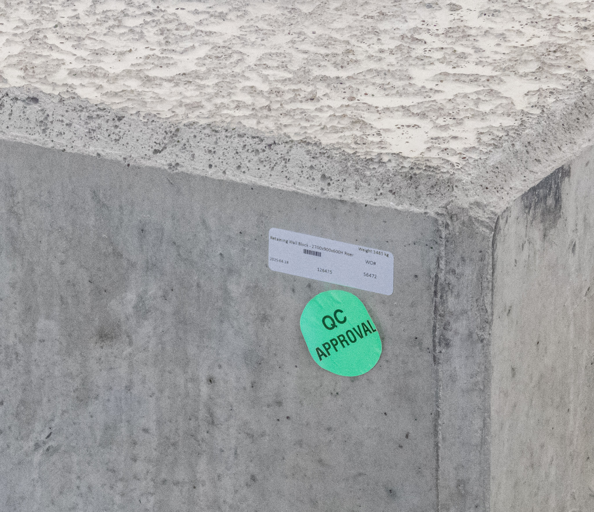 Quality-control approval sticker and identification label on a concrete component