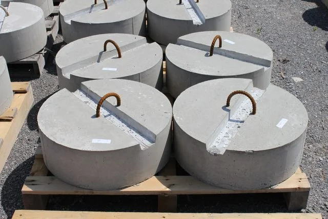 Precast concrete dock weights with lifting rings in the yard
