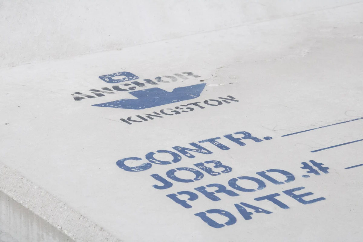 Anchor Kingston stamp and manufacturing identification fields on a concrete surface