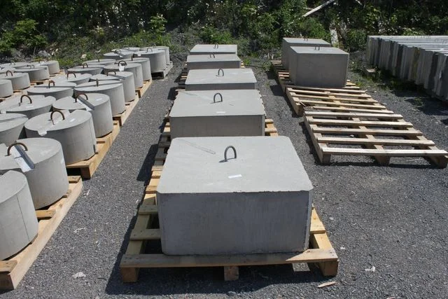 Square concrete dock weights arranged on pallets