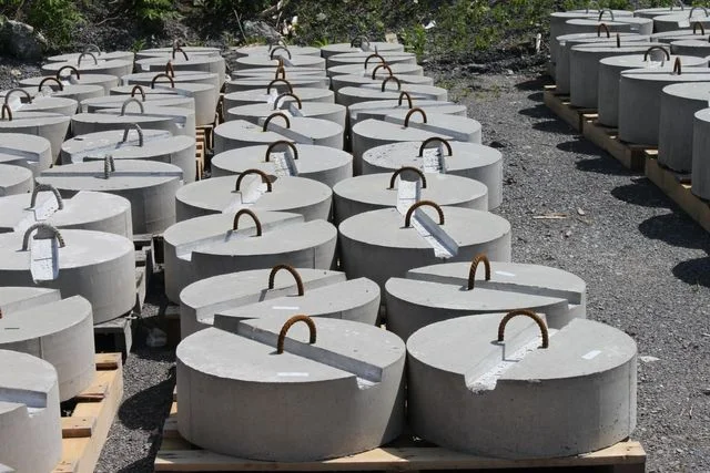 Round and rectangular precast dock weights in the Anchor Concrete yard