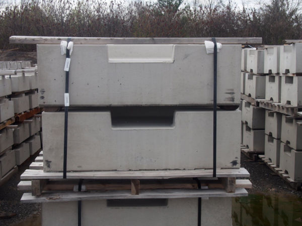 Precast rail-platform curb top components stored on a pallet